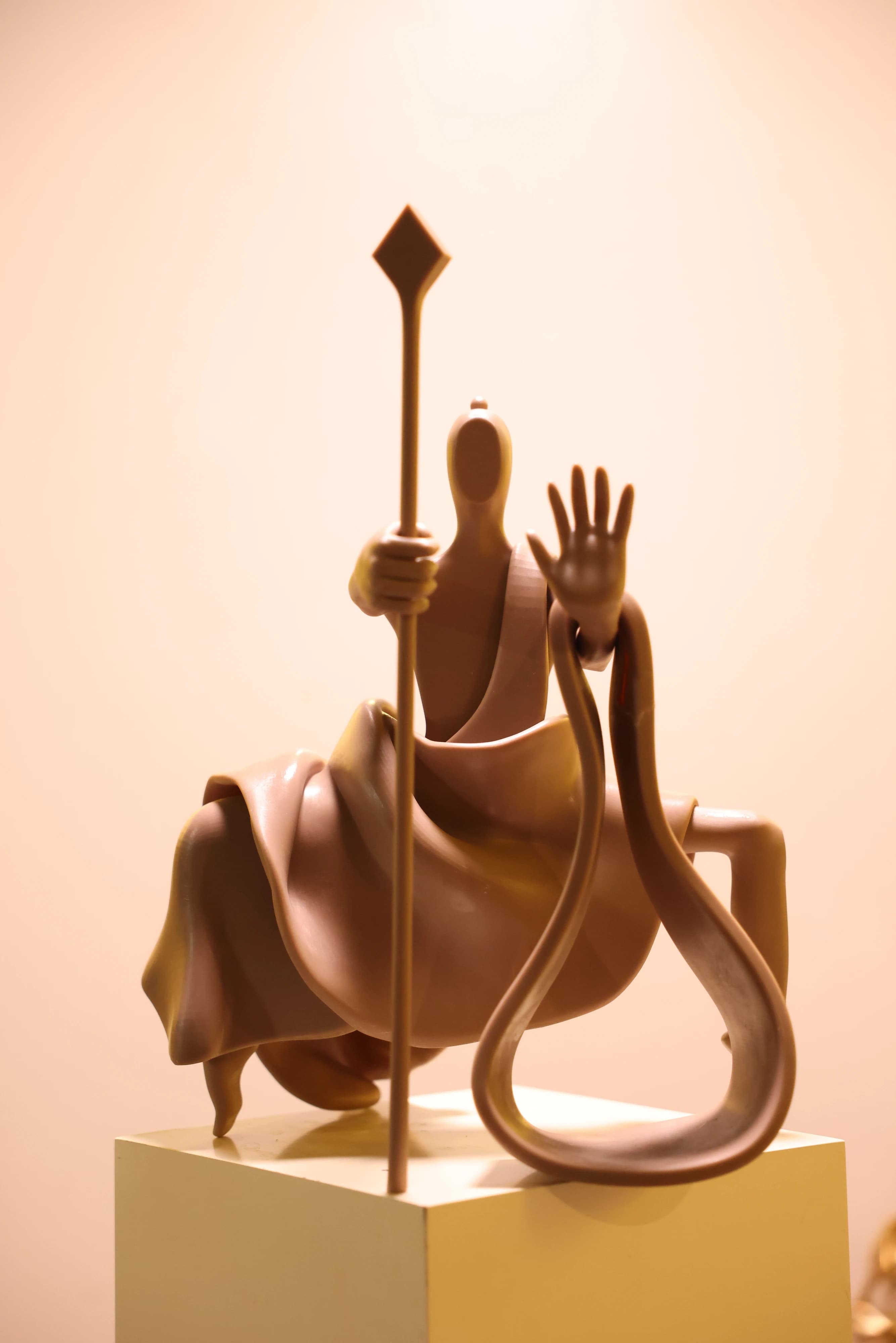 Close view of a staff-bearing figure mounted on an animal